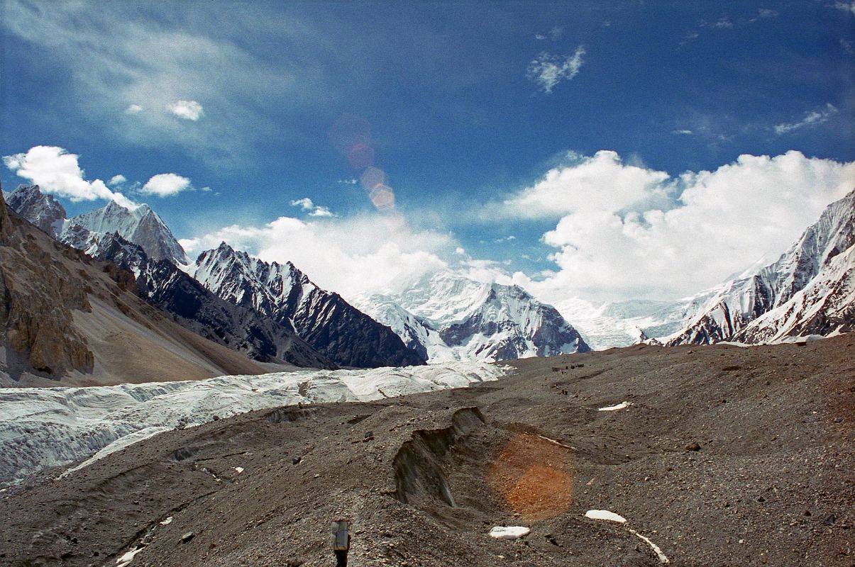 08 Trekking On The Upper Baltoro Glacier Towards Shagring Camp With Gasherbrum VI, Baltoro Kangri And Kondus Peak Gasherbrum VI, Baltoro Kangri and Kondus Peak lie ahead as we trek on the Upper Baltoro Glacier towards Shagring Camp.